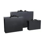 disply three black custom box style paper bags with ribbon handles in different sizes