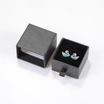 a black custom cardboard earring drawer box with a pair of earrings inside