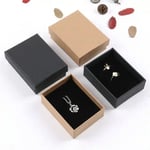 two black jewelry boxes and two kraft jewelry boxes, and two of them are opening with jewelry inside