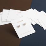 a bunch of custom paper jewelry cards