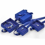 four custom navy blue jewelry boxes with ribbon decoration and jewelry inside