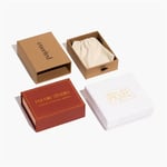 three well-made custom jewelry boxes with pouches, one is brick red, one is white, one is brown, placed like a windmill