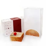 two empty custom SOS paper bags for bread packaging with some slips of bread and a cherry beside