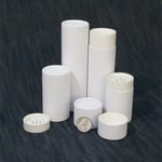 a bunch of white custom powder shaker paper tubes in different height