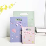 three custom colorful die cut paper bags with flap in different appearance and sizes