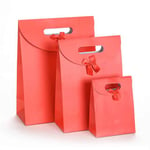 three red custom solid color die cut paper bags with flap