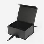 the black custom flip top gift box with ribbon closure in the open state