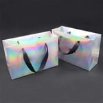 two custom holographic paper bags with ribbon handles