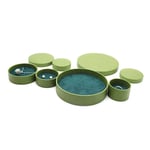 a bunch of green custom round jewelry boxes and some of them have jewelry inside