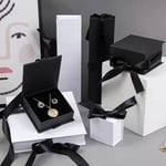 a bunch of custom ribbon flip jewelry boxes