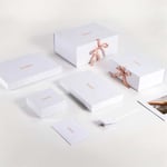 a bunch of custom luxury eco-friendly clothing rigid boxes with ribbon closure