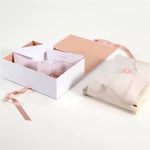 one custom luxury eco-friendly clothing rigid box with ribbon closure and some accessories and a package of clothes