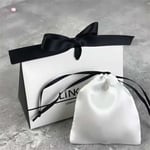 one custom gift triangle style paper bag with a satin bag