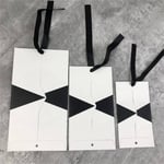 three unfolded custom gift triangle style paper bags in different sizes