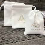 the front of three white Custom Velvet Drawstring Pouches